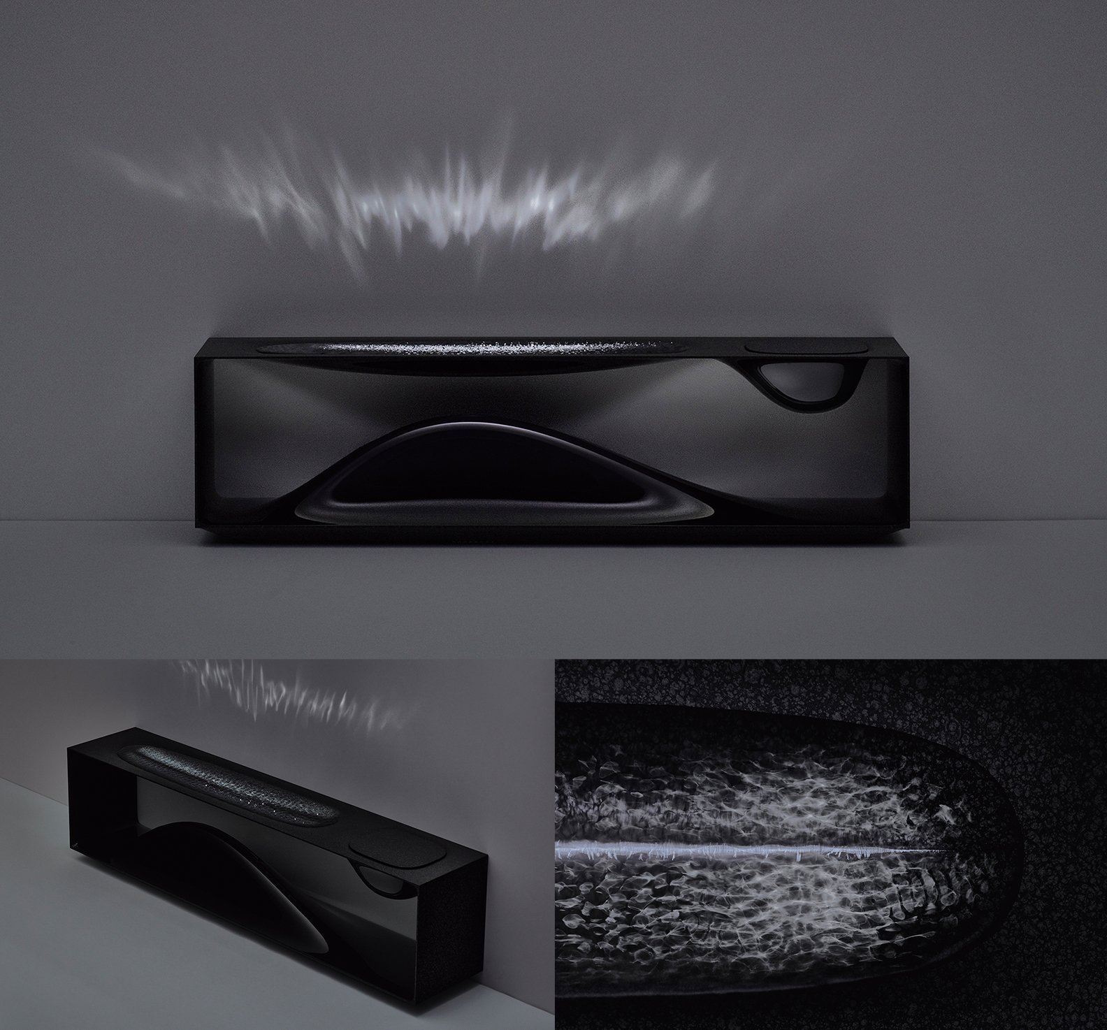 黒い長方形のスピーカー、内部に波状の曲線と凹凸、上面に光の反射、三方向からの視点