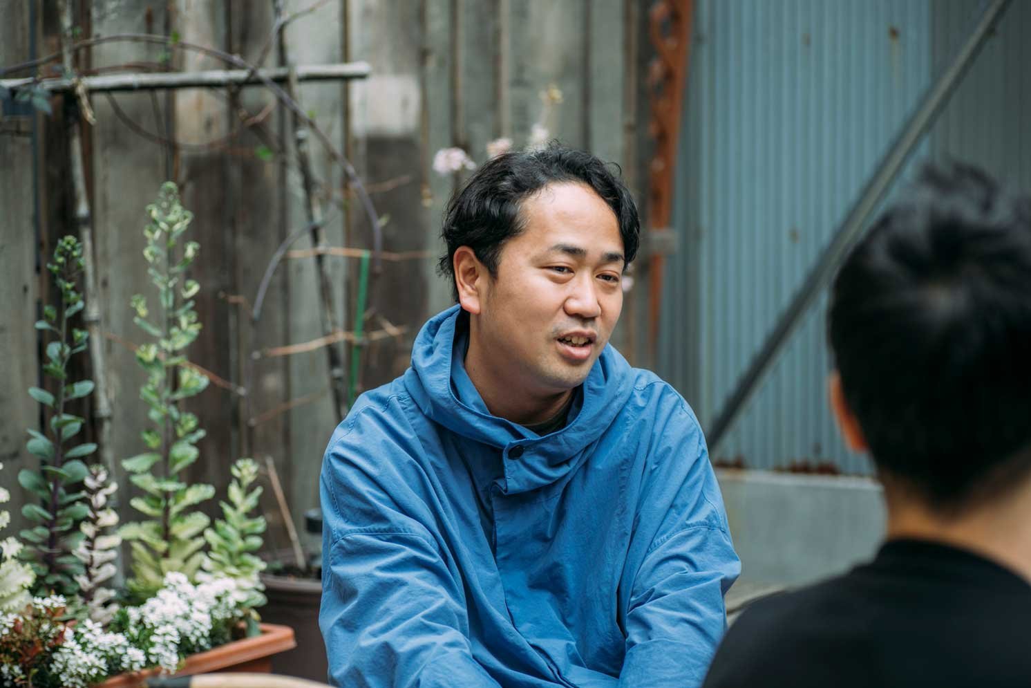 屋外で向かい合い座り、会話する二人の人物のクローズアップ