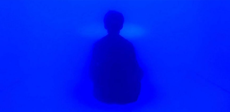 A man is medicating in a meditation pod filled with dry mist