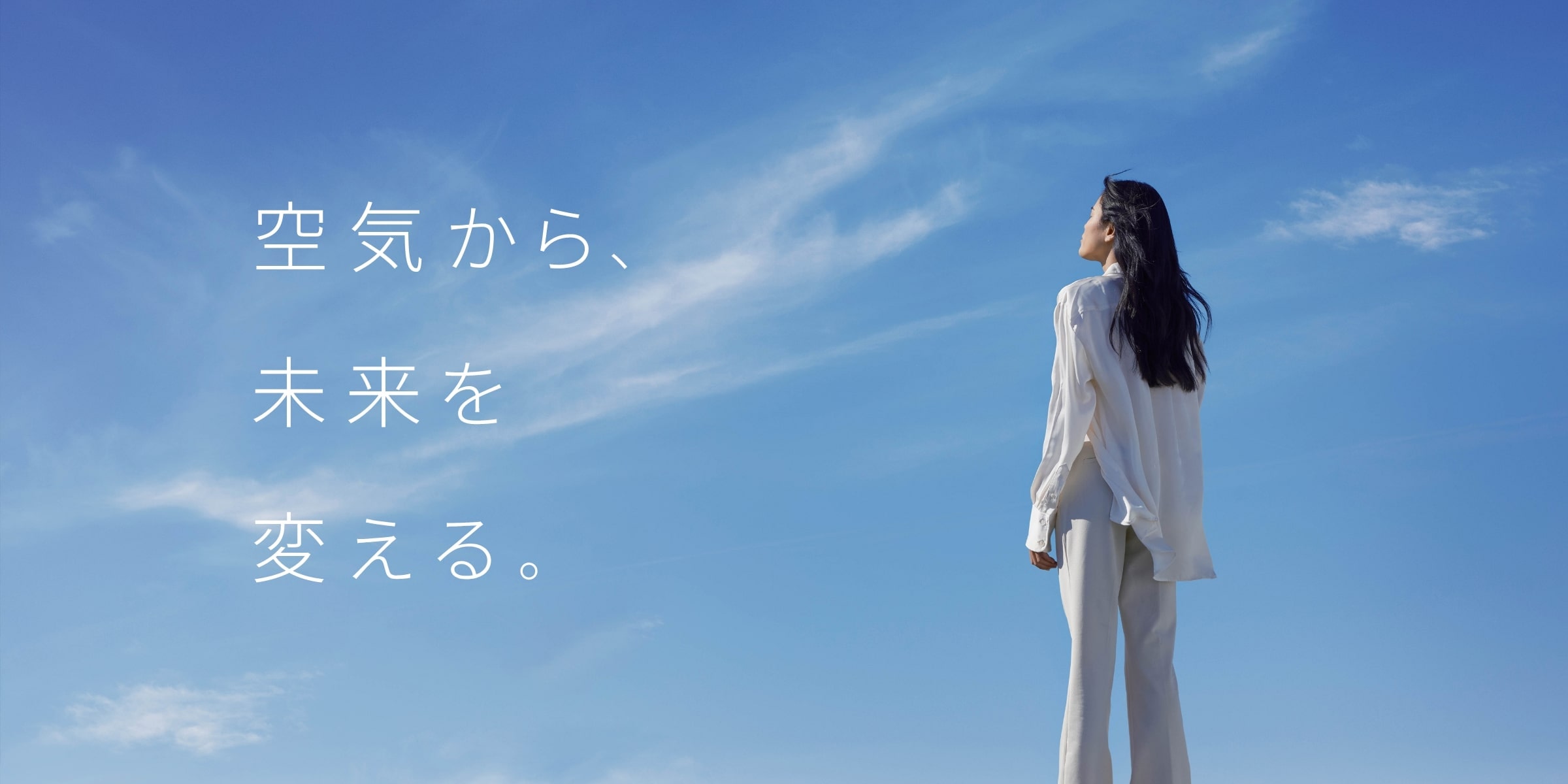 若い女性が空を見上げている画像